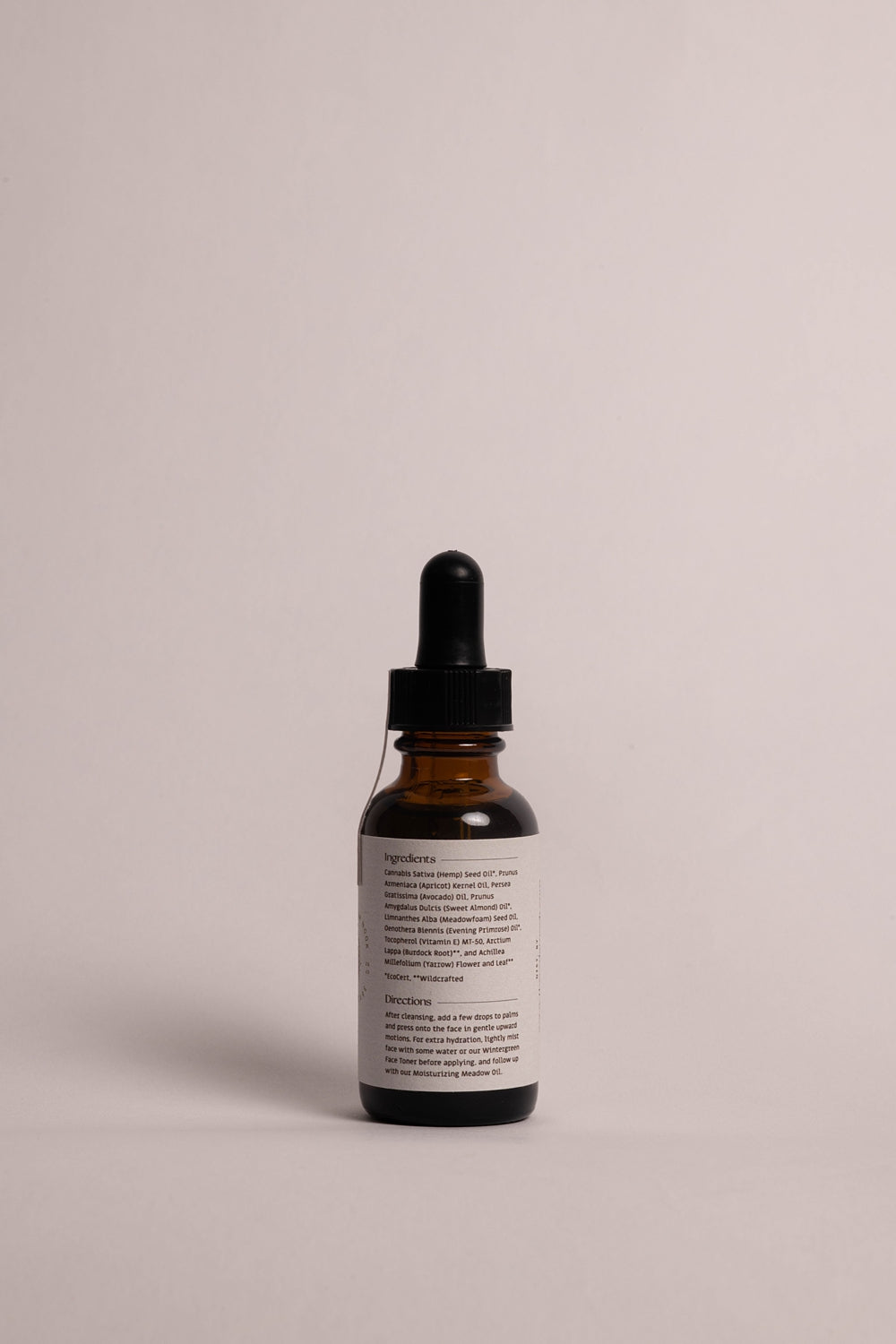 The Cedar Nook | Yarrow Face Serum for dry and sensitive skin in a 1 oz amber glass bottle with dropper, back view showing list of ingredients and directions
